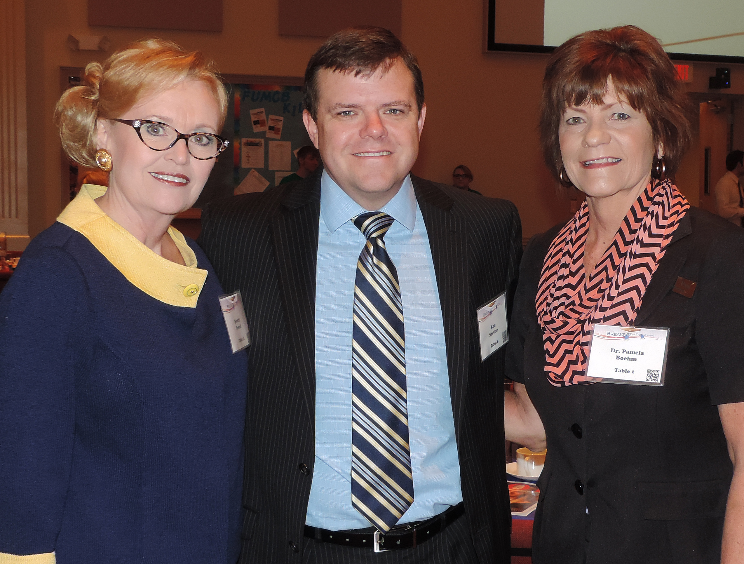 Burleson Opportunity Fund board members Beverly Volkman-Powell, chairman, Ken Shetter, Burleson Mayor, and Dr. Pamela Boehm, Hill College president, compare notes at the Breakfast of Champions held this week to benefit student scholarships.