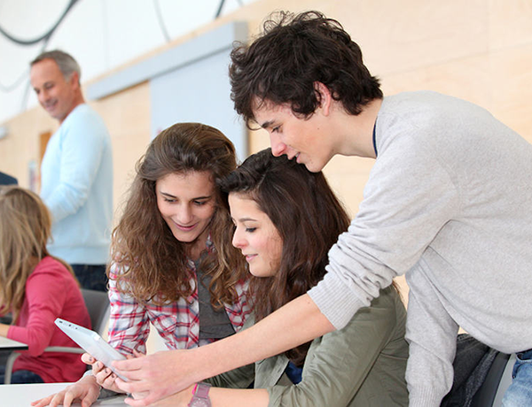 Students working together on a tablet