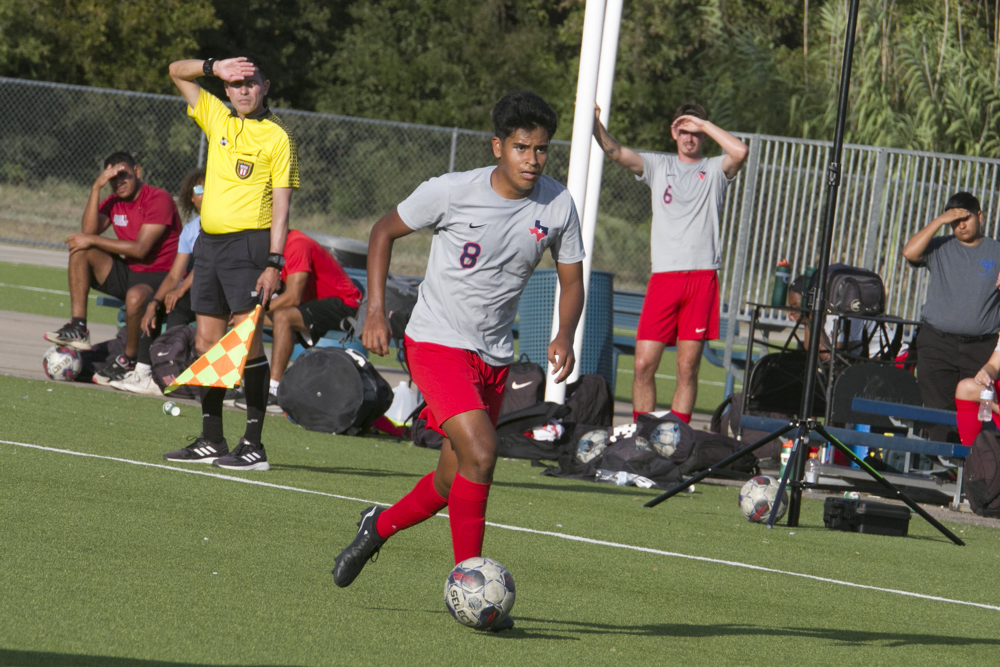 Rebels soccer player dribbling ball