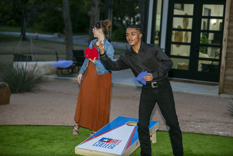 Attendee playing cornhole 